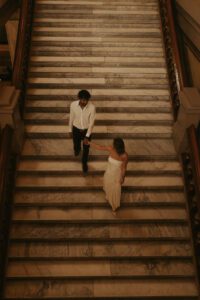 Couple posing on the marble staircase inside the Indiana Statehouse.