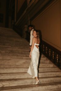Couple posing on the marble staircase inside the Indiana Statehouse.